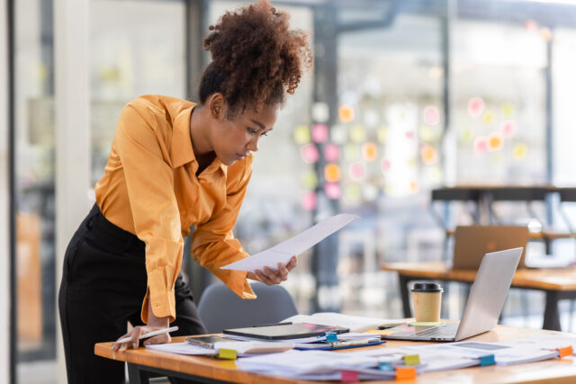 Entrepreneur reviewing legal documents for new business planning and protection