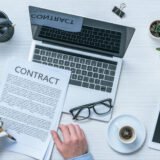 Business owner reviewing AI-generated contracts on a laptop to assess legal riskBusiness owner reviewing AI-generated contracts on a laptop to assess legal risk