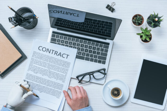 Business owner reviewing AI-generated contracts on a laptop to assess legal riskBusiness owner reviewing AI-generated contracts on a laptop to assess legal risk