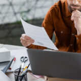 Business owner reviewing contract terms to confirm who owns work product