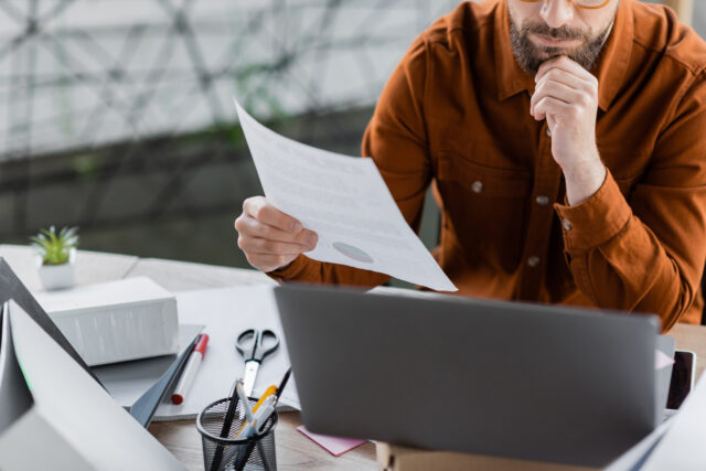 Business owner reviewing contract terms to confirm who owns work product